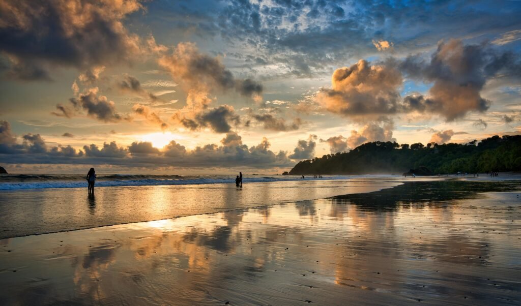 pexels-photo-29635789-29635789 Beautiful sunset over a tranquil beach in Costa Rica, capturing vibrant reflections and serene atmosphere.