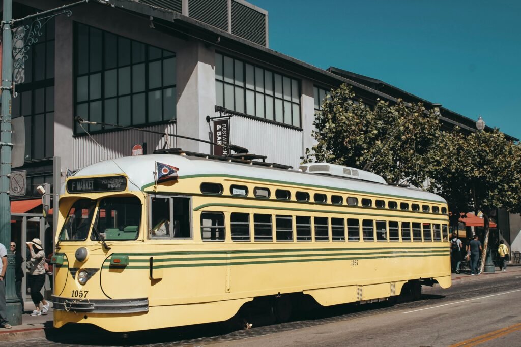 pexels-photo-2263673-2263673 A classic yellow vintage streetcar on a sunny day in the cityscape.