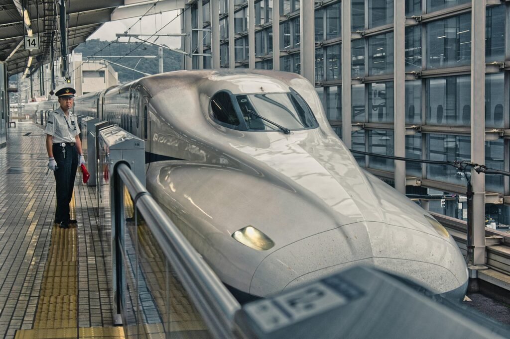 Shinkansen bullet train at a platform in Kyoto Station, Japan, highlighting modern high-speed travel.