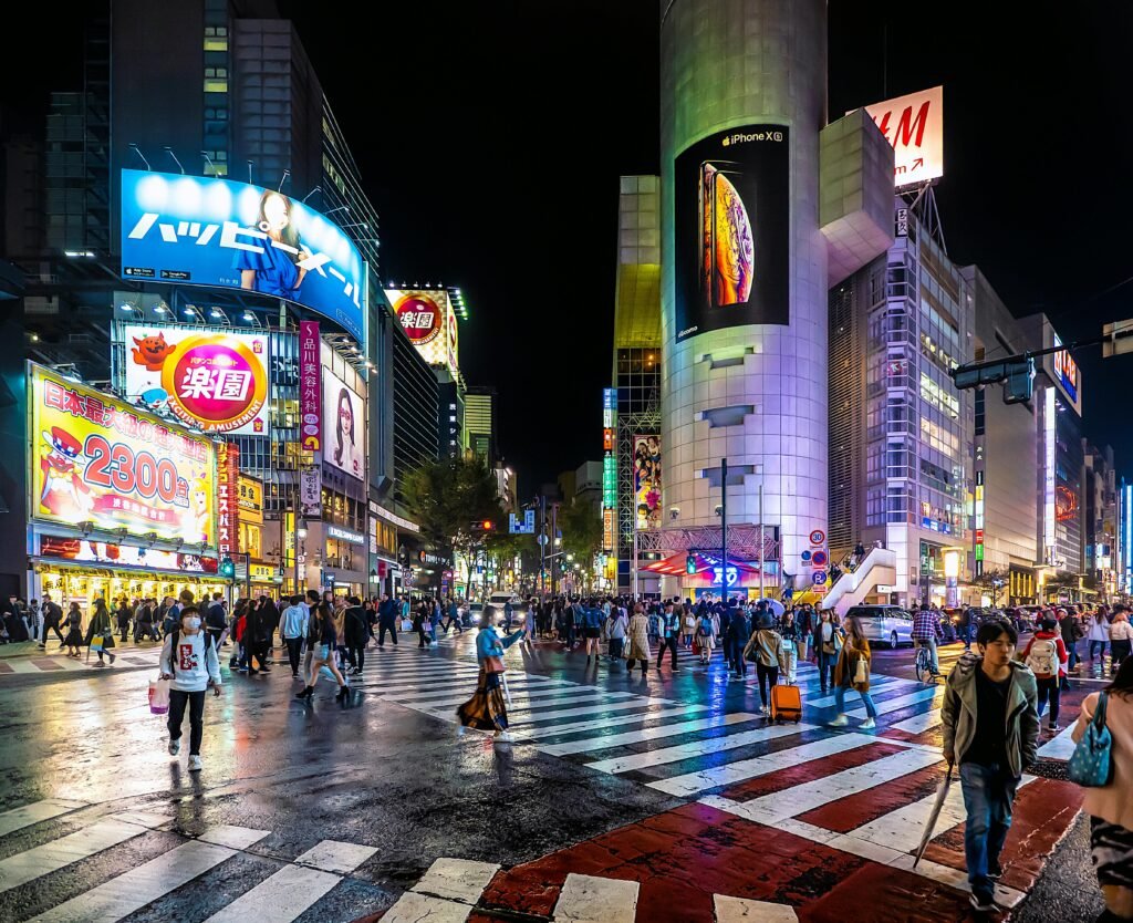 Explore the bustling nightlife at Shibuya Crossing, Tokyo's iconic pedestrian scramble, filled with vibrant lights and crowds.