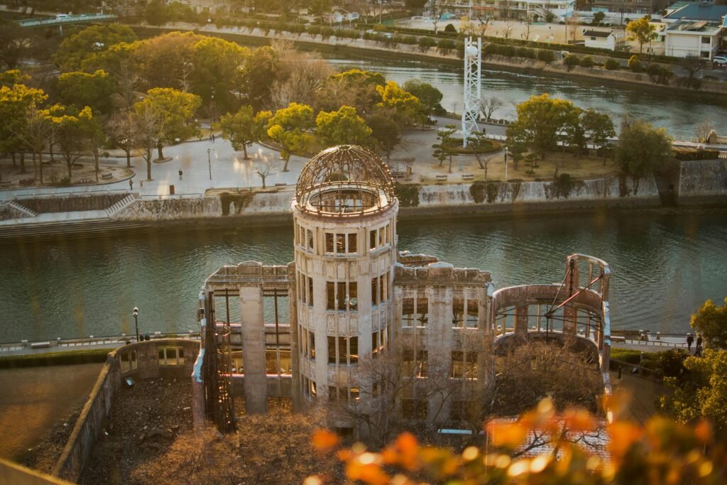 pexels-photo-30841503-30841503 Aerial photograph of the Hiroshima Peace Memorial in Japan, capturing the serene sunset over the iconic landmark.