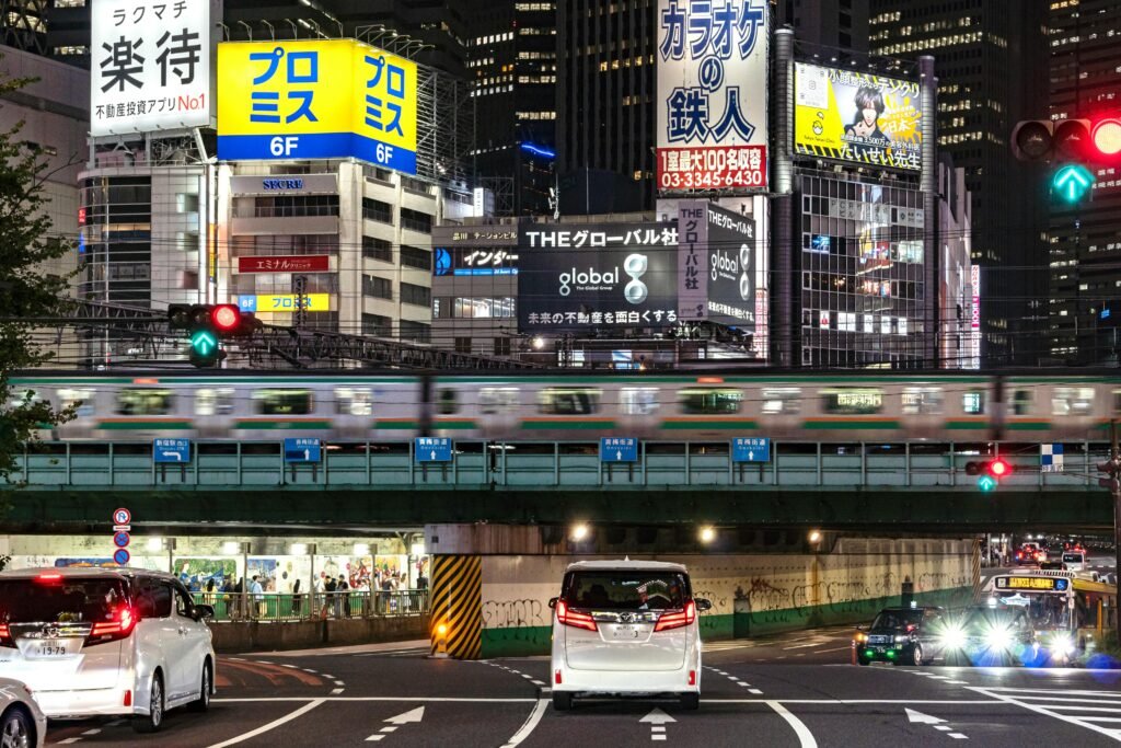 pexels-photo-31258215-31258215 Tokyo cityscape at night with streetcars, trains, and colorful billboards, capturing the energy of the urban landscape.