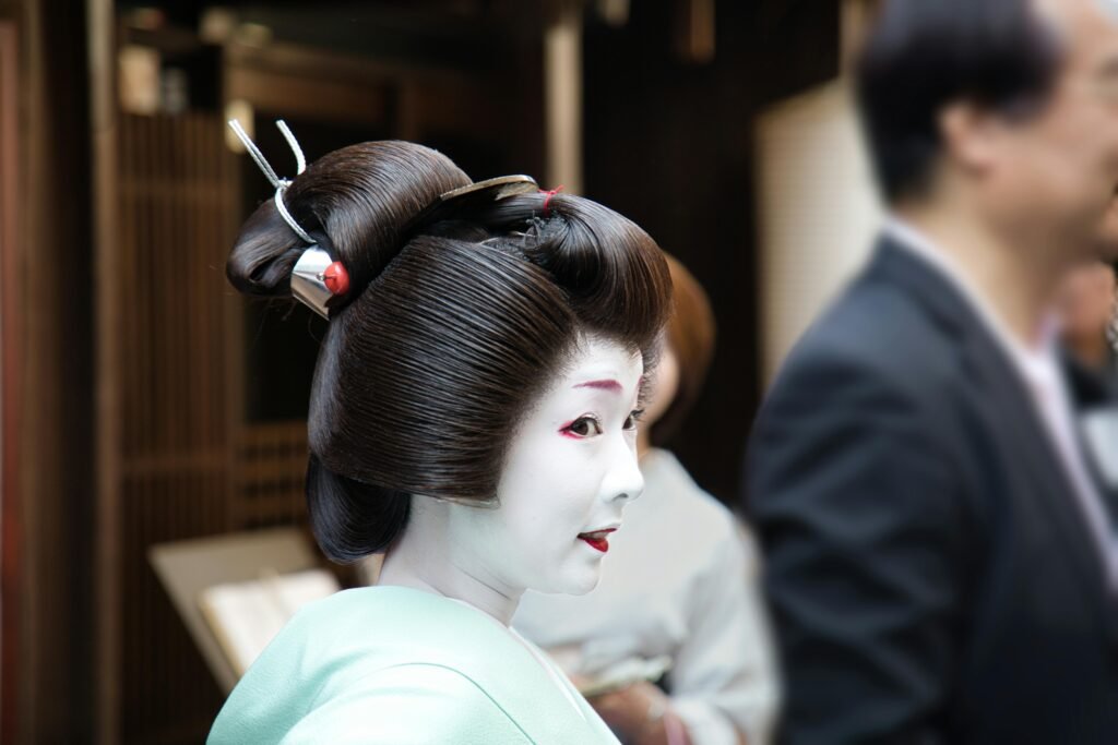 Portrait of a Geisha with traditional makeup in Kyoto, showcasing cultural heritage.
