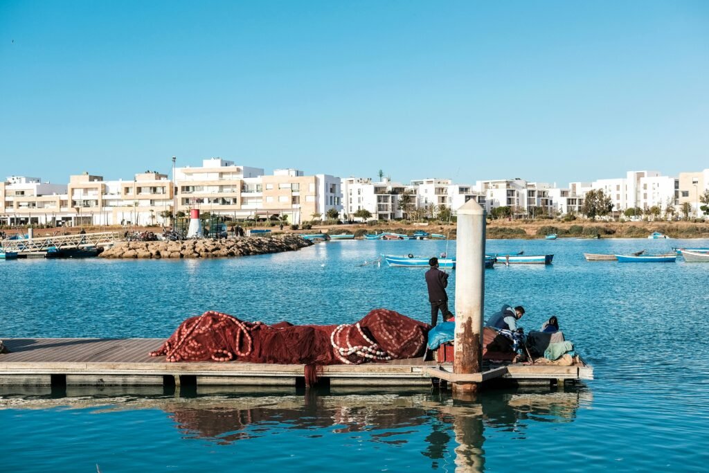 pexels-photo-30532024-30532024 Picturesque view of Rabat's waterfront, featuring boats and modern architecture.