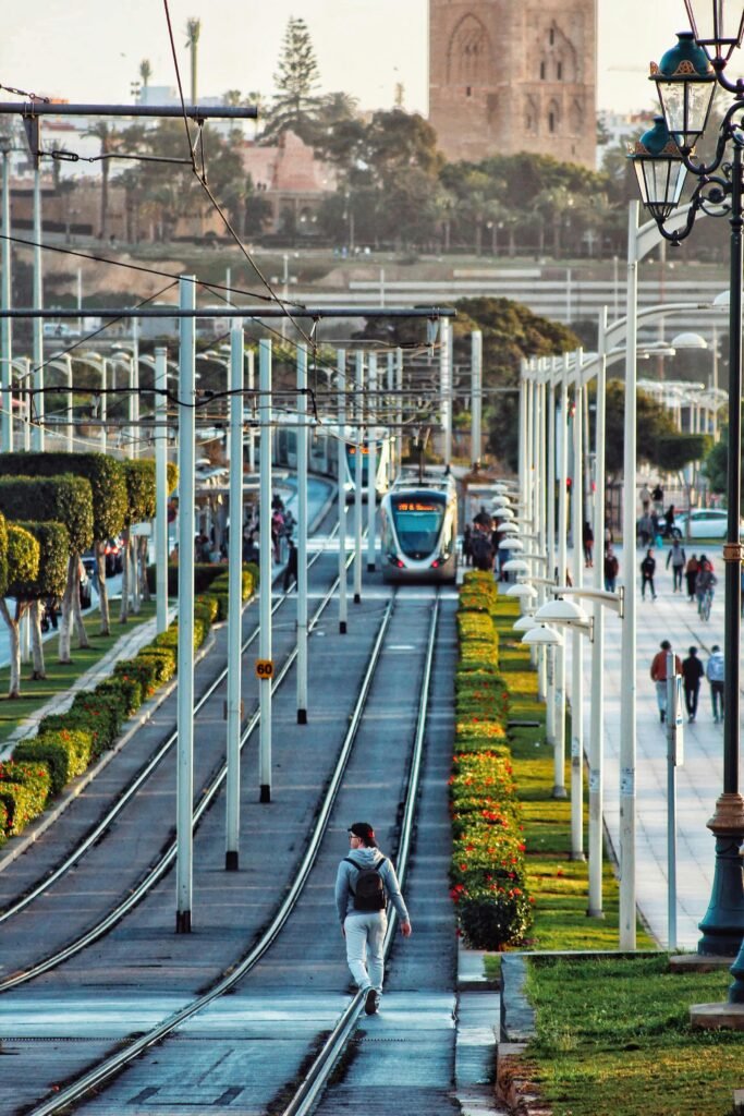 pexels-photo-30618013-30618013 A bustling street scene with a tramway in Rabat, Morocco, featuring the iconic Hassan Tower.