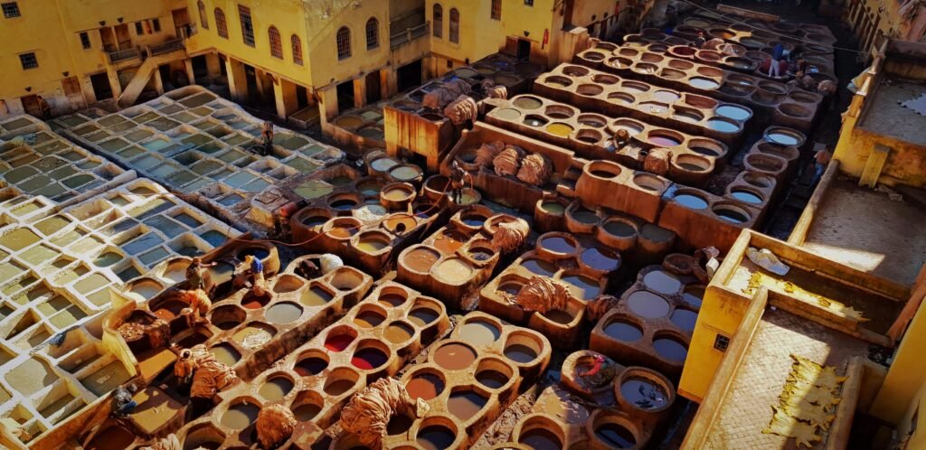 Aerial view of the ancient tanneries in Fes, Morocco, showcasing traditional leather dyeing techniques.
