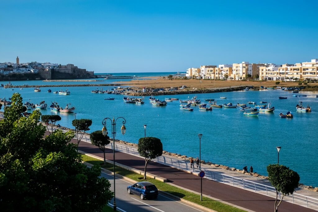 Explore the vibrant harbor of Rabat with traditional boats and coastal architecture.