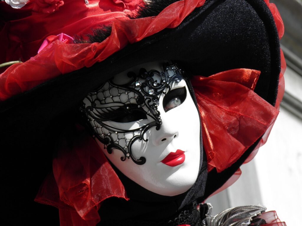 Red Venetian carnival mask displayed in Venice, Italy during the famous Venice Carnival.