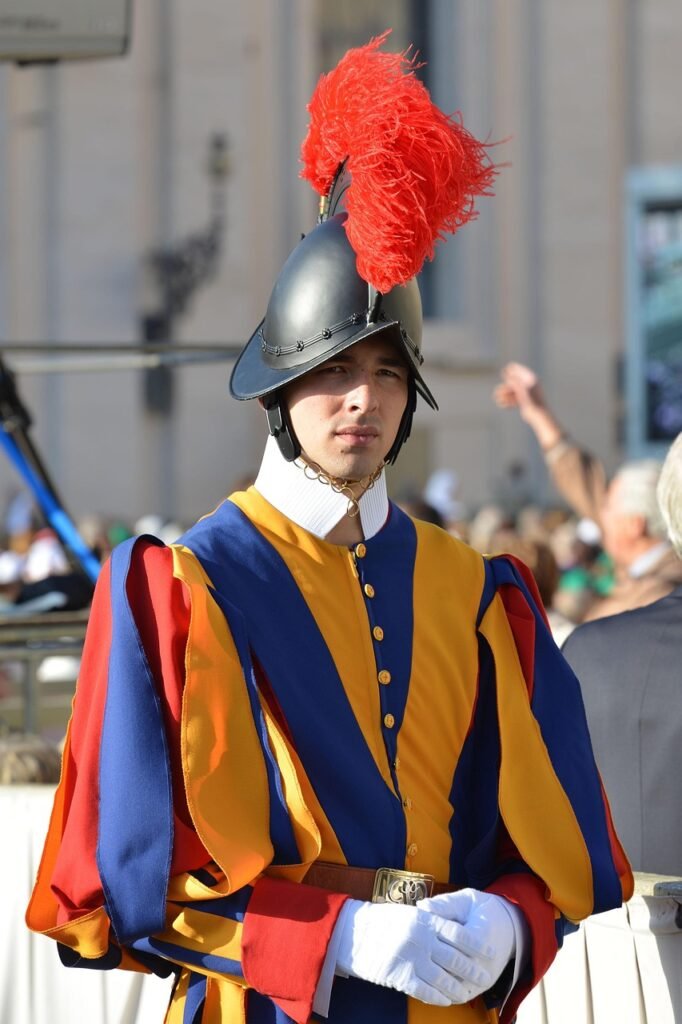 Swiss Guard standing in St. Peter's Square outside St. Peter's Basilica in Vatican City, Rome, Italy.
