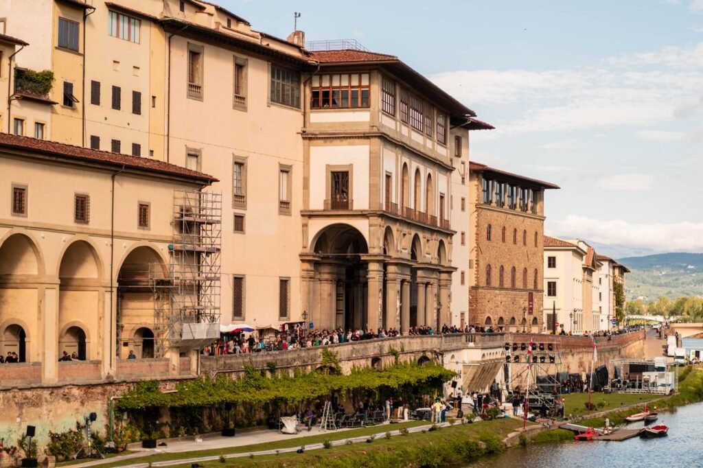 Historic Uffizi Gallery by the Arno River in Florence, showcasing Renaissance architecture.