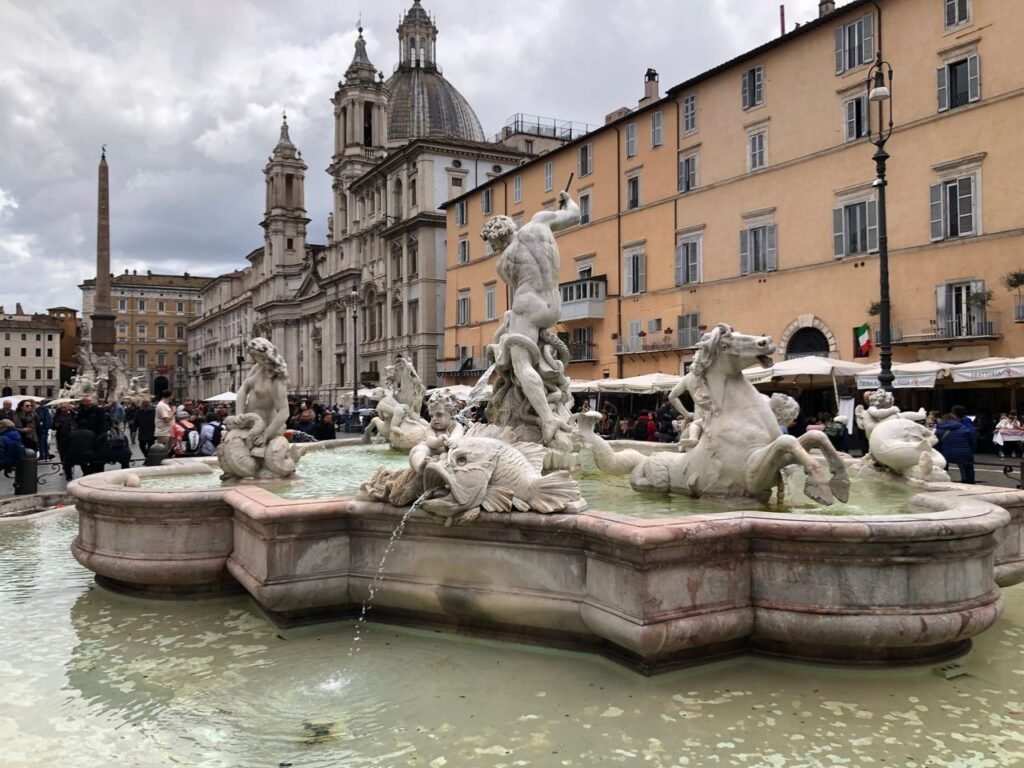 Neptune statue in Piazza Navona, Rome's iconic square, with Baroque architecture.
