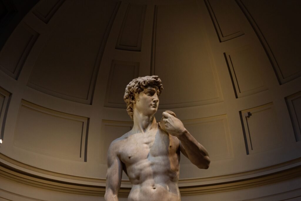 Marble statue of David in indoor gallery setting, Florence, Italy.