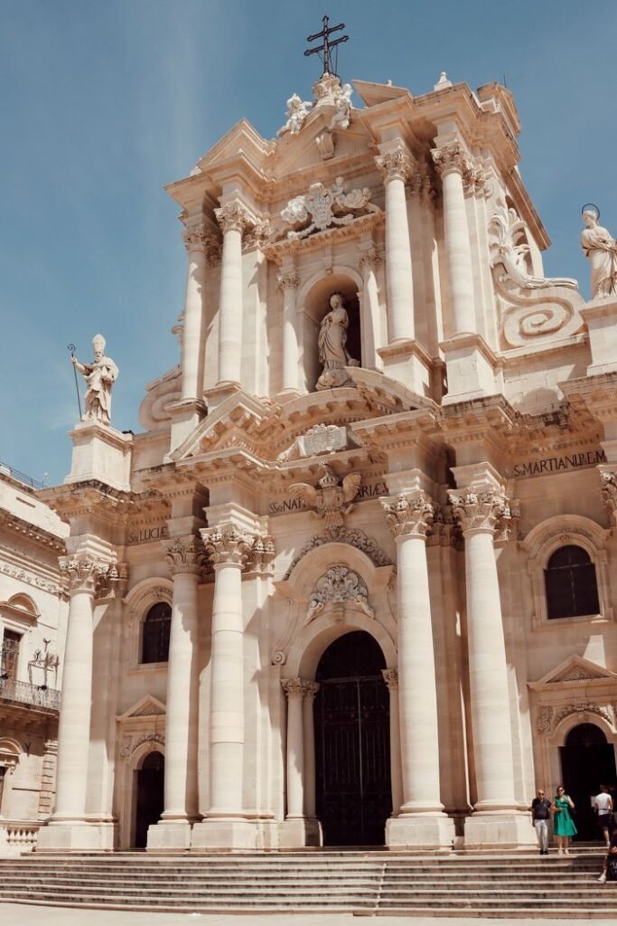 Stunning Baroque cathedral facade in Syracuse, Sicily, showcasing ancient architecture and religious heritage.