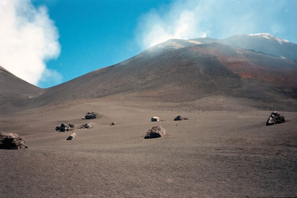 Stunning volcanic terrain of Mount Etna under a clear blue sky, Sicily, Italy.