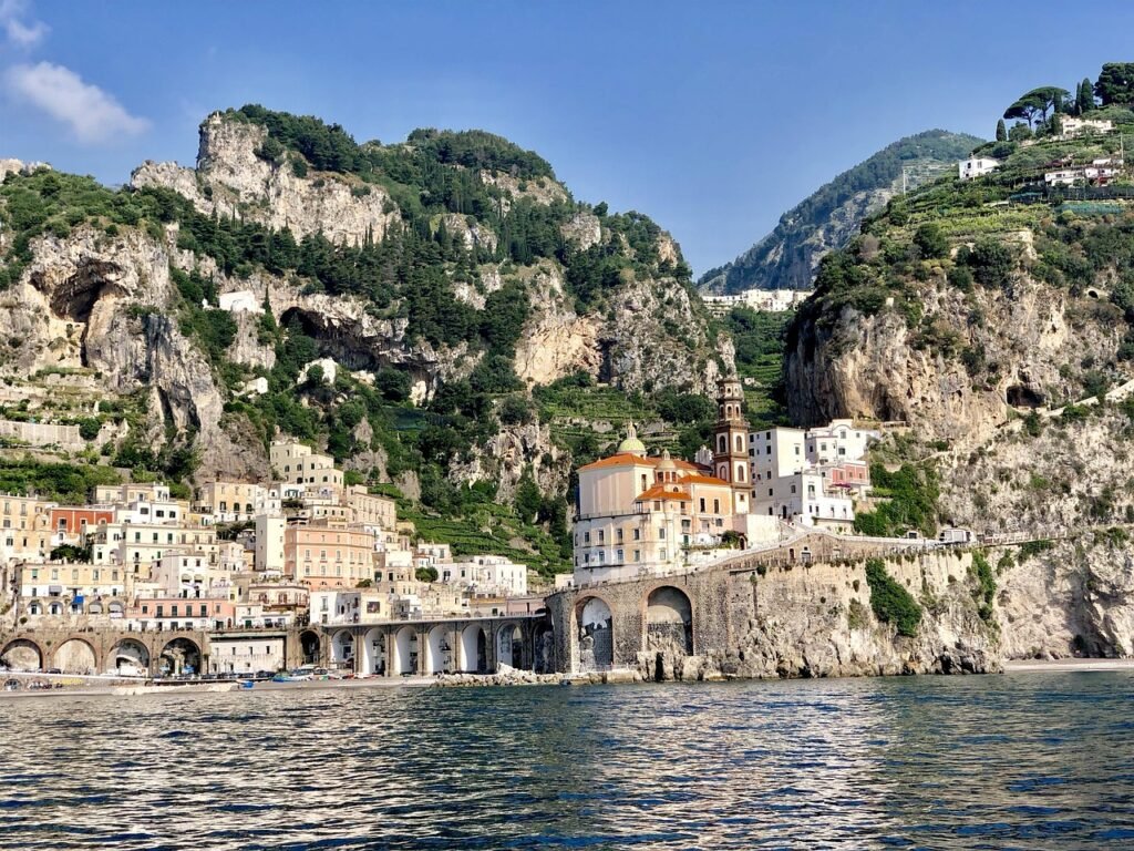 Amalfi Coast in Italy with dramatic cliffs, Mediterranean Sea, coastal mountains, and the colorful town of Positano.