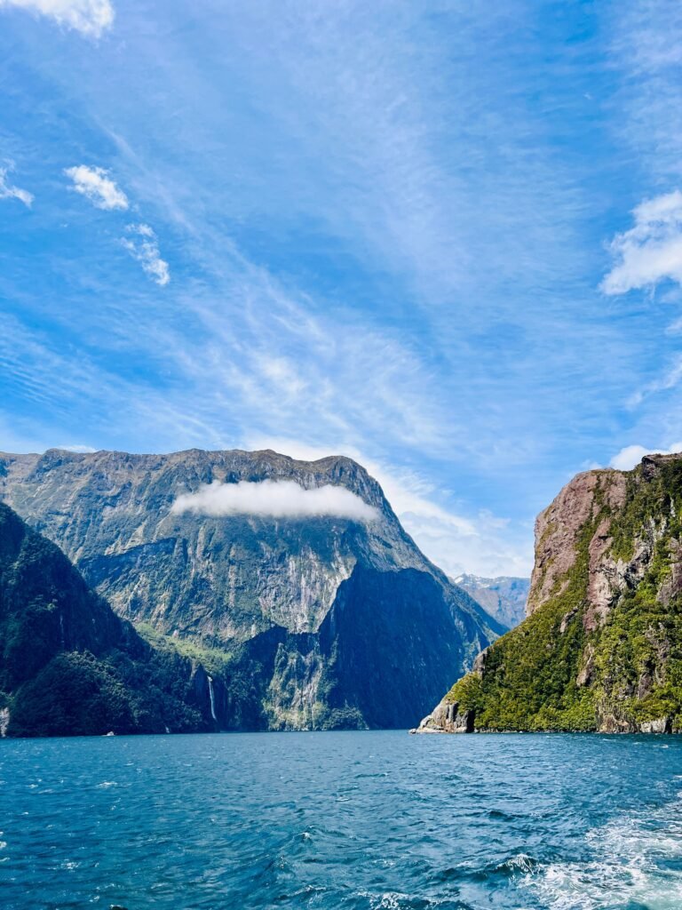 Breathtaking view of Milford Sound with majestic cliffs and clear skies in New Zealand.