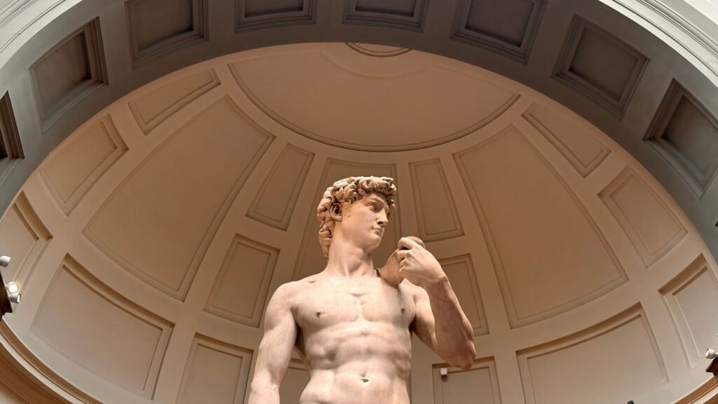 Low angle view of Michelangelo's David sculpture in Florence museum dome.