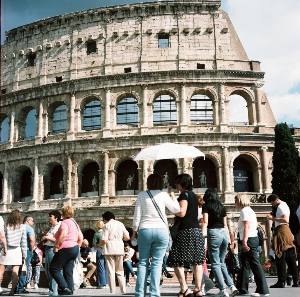 Visitors gather at the iconic Colosseum in Rome, capturing its historic charm on a sunny day. Ideal place to visit during a 5 day italy itinerary
