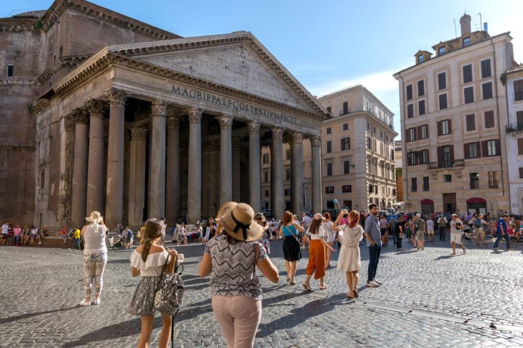 A vibrant scene of tourists visiting the iconic Pantheon in Rome, Italy, on a sunny day.
