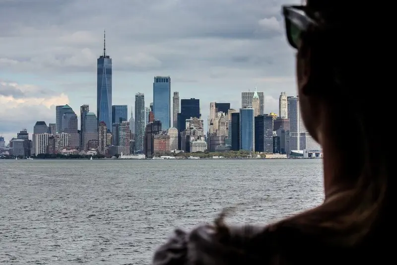 A woman admiring the New York City skyline from a distance during a 5 day NYC itinerary.