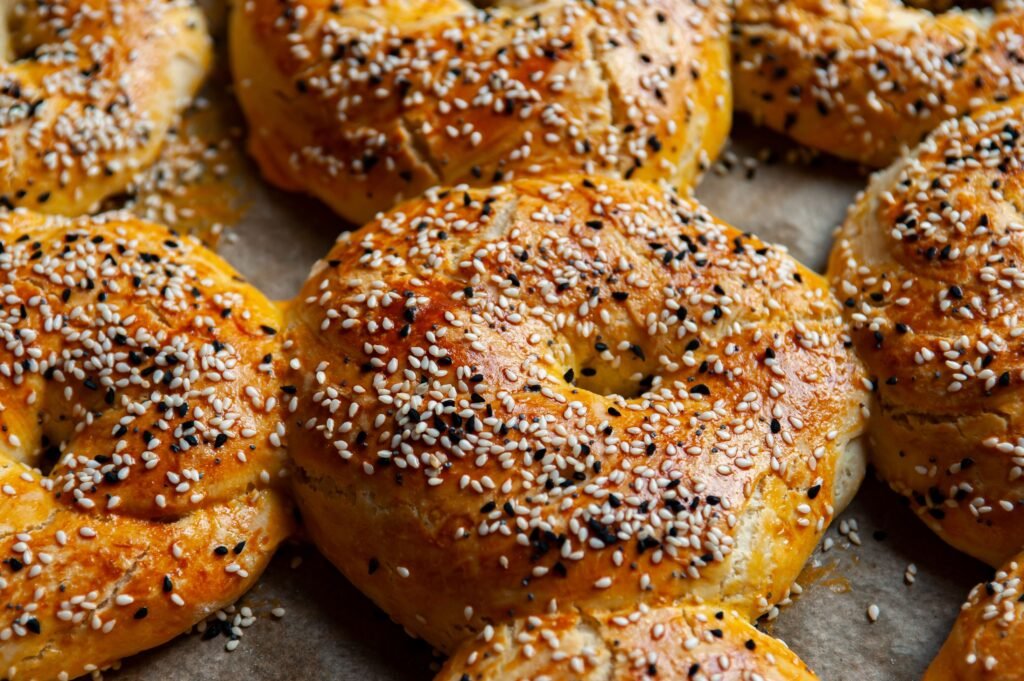 Golden brown bagels topped with sesame seeds straight from the oven.
