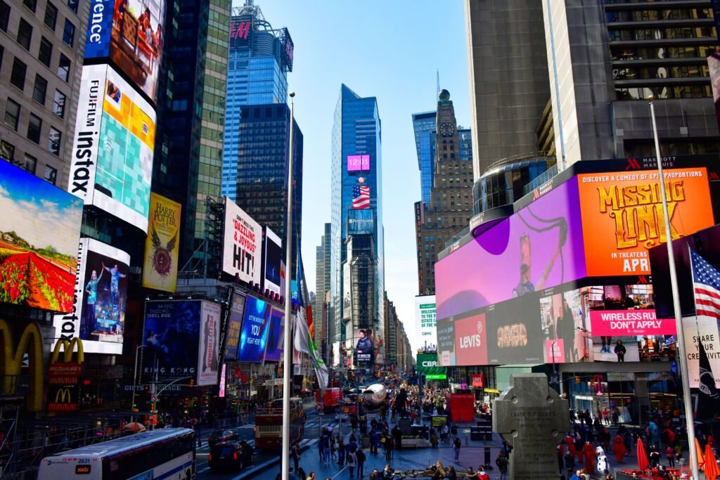 Colorful view of Times Square, New York City featuring skyscrapers and bustling urban life.